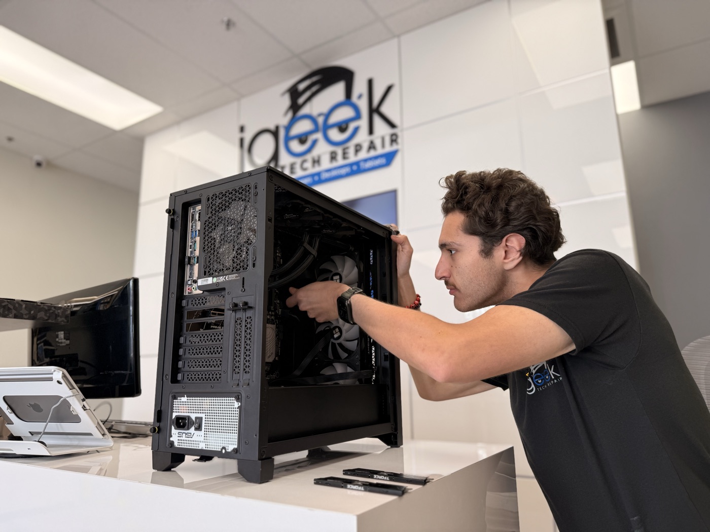 Ryan assembling a custom gaming PC at the iGeek front counter