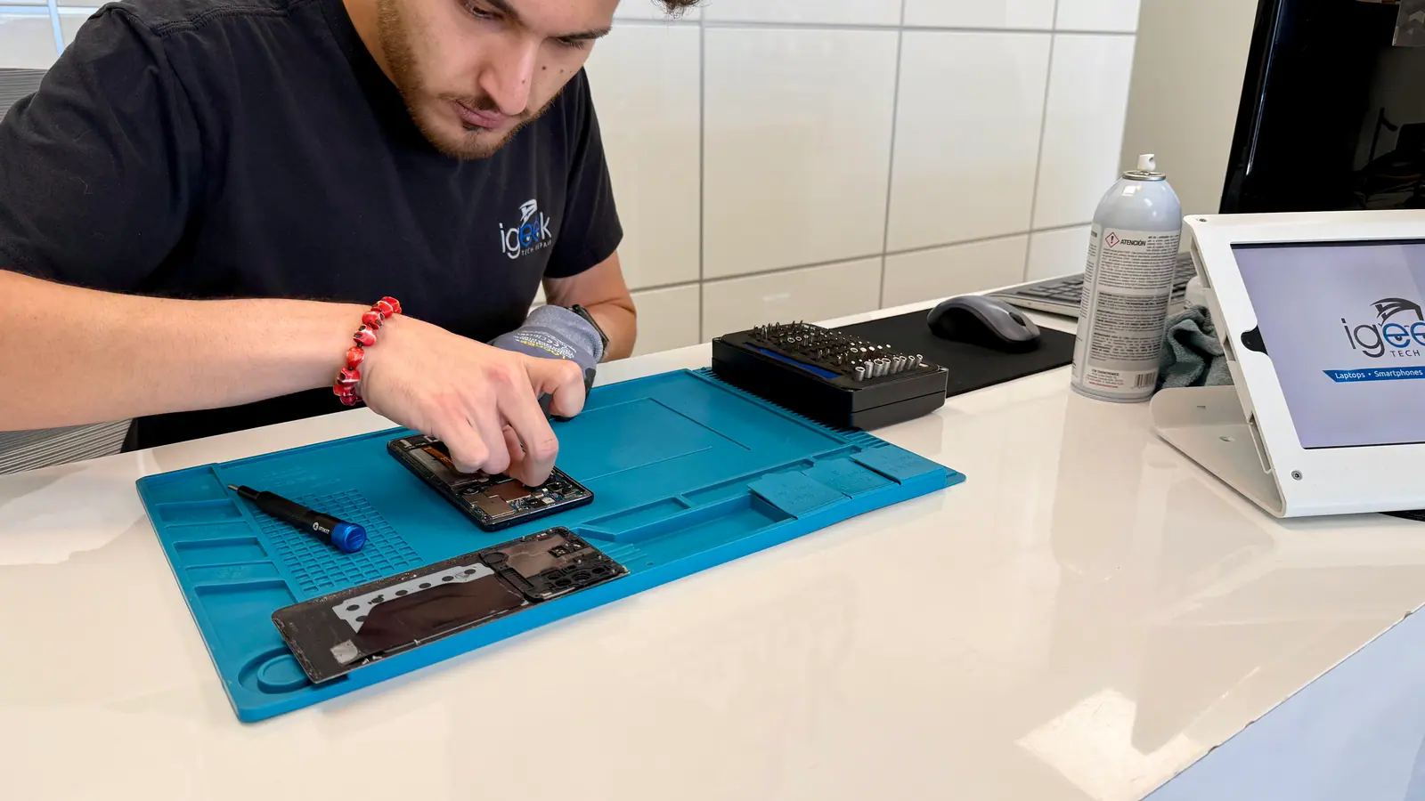Close view of a phone with its display lifted during a screen repair